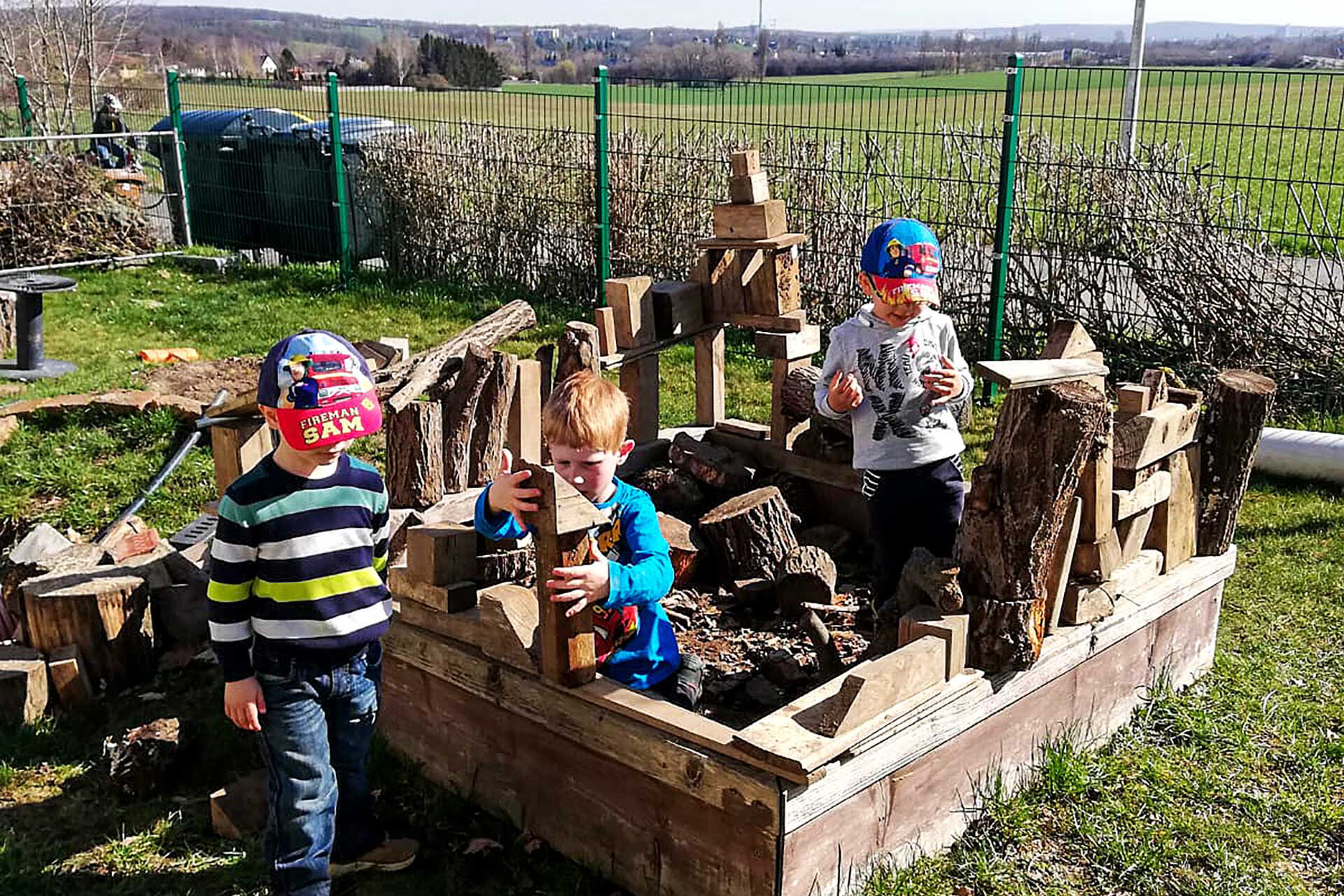 In der Bewegungsbaustelle im Garten können die Kinder ihre Ideen in die Tat umsetzen und nach Lust und Laune bauen und konstruieren. Materialien wie Ziegel- und Gasbetonsteine, Bretter und Stämme, Rohre und Reifen stehen zur Verfügung.